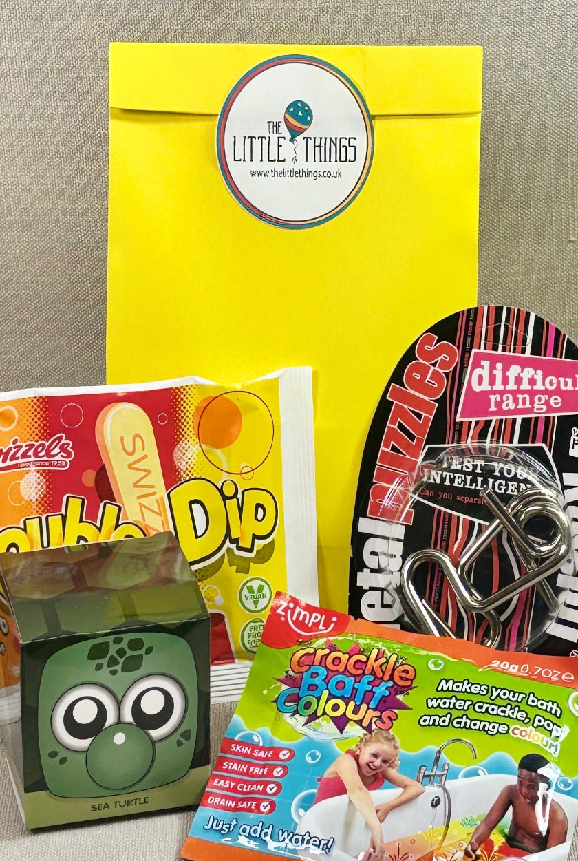 Yellow paper party bag with sticker. includes a double dip, metal puzzle and crackle baff colours.