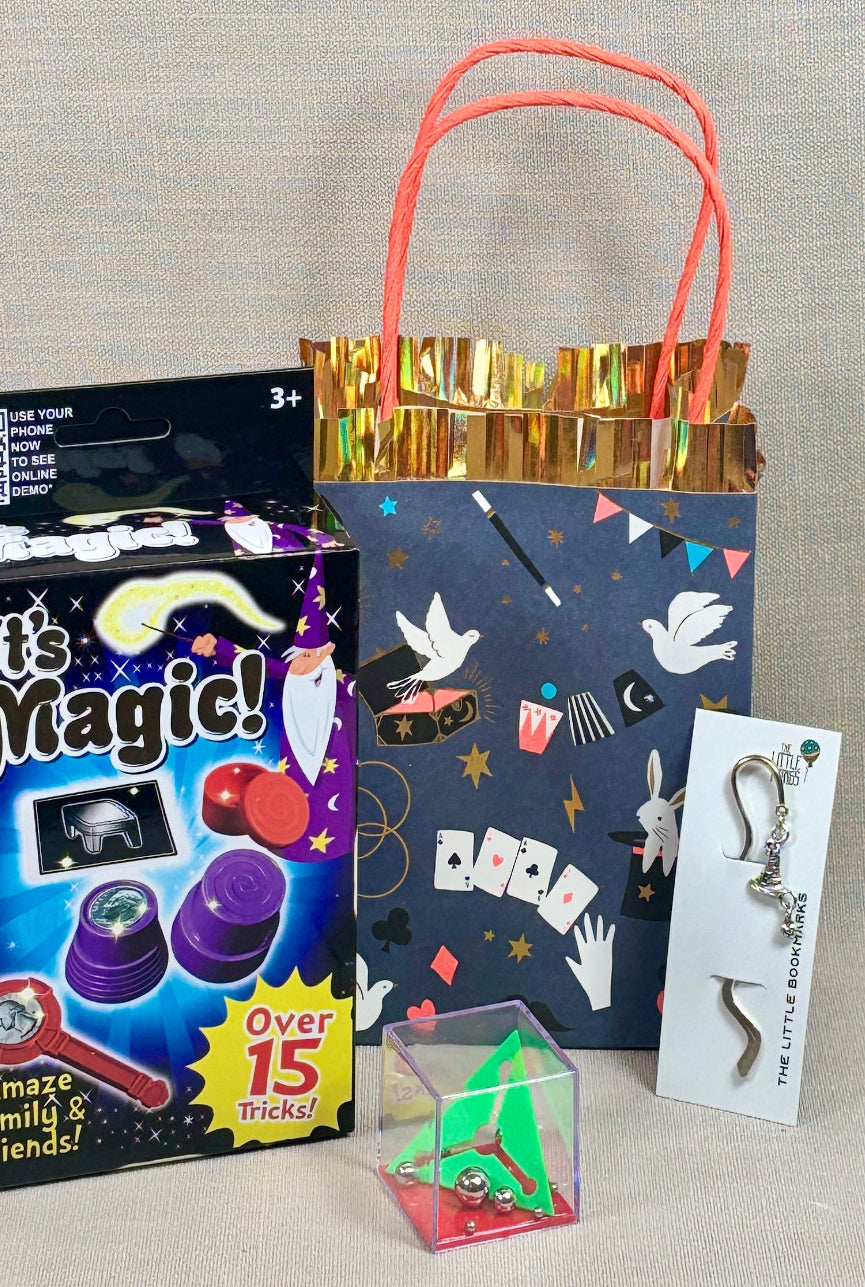 Magic kit with paper party bag with magic print, a small green cube puzzle , and a wizard hat book mark. Perfect for Harry Potter Parties.