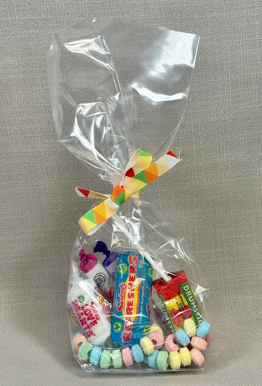 Clear cellophane bag with retro sweets ties with a colourful ribbon.