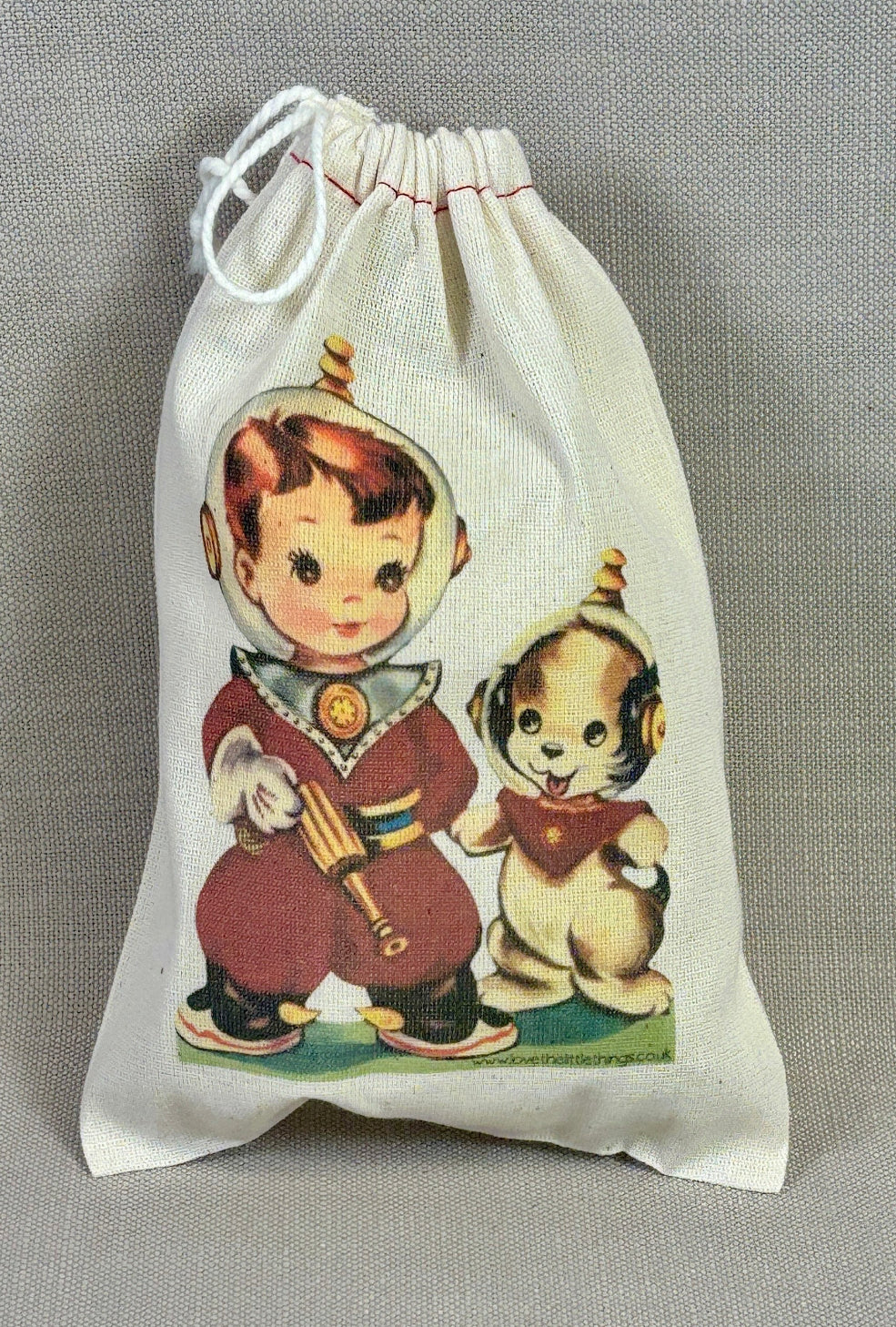 Drawstring bag with vintage-style illustration of a boy and dog on a gray fabric background