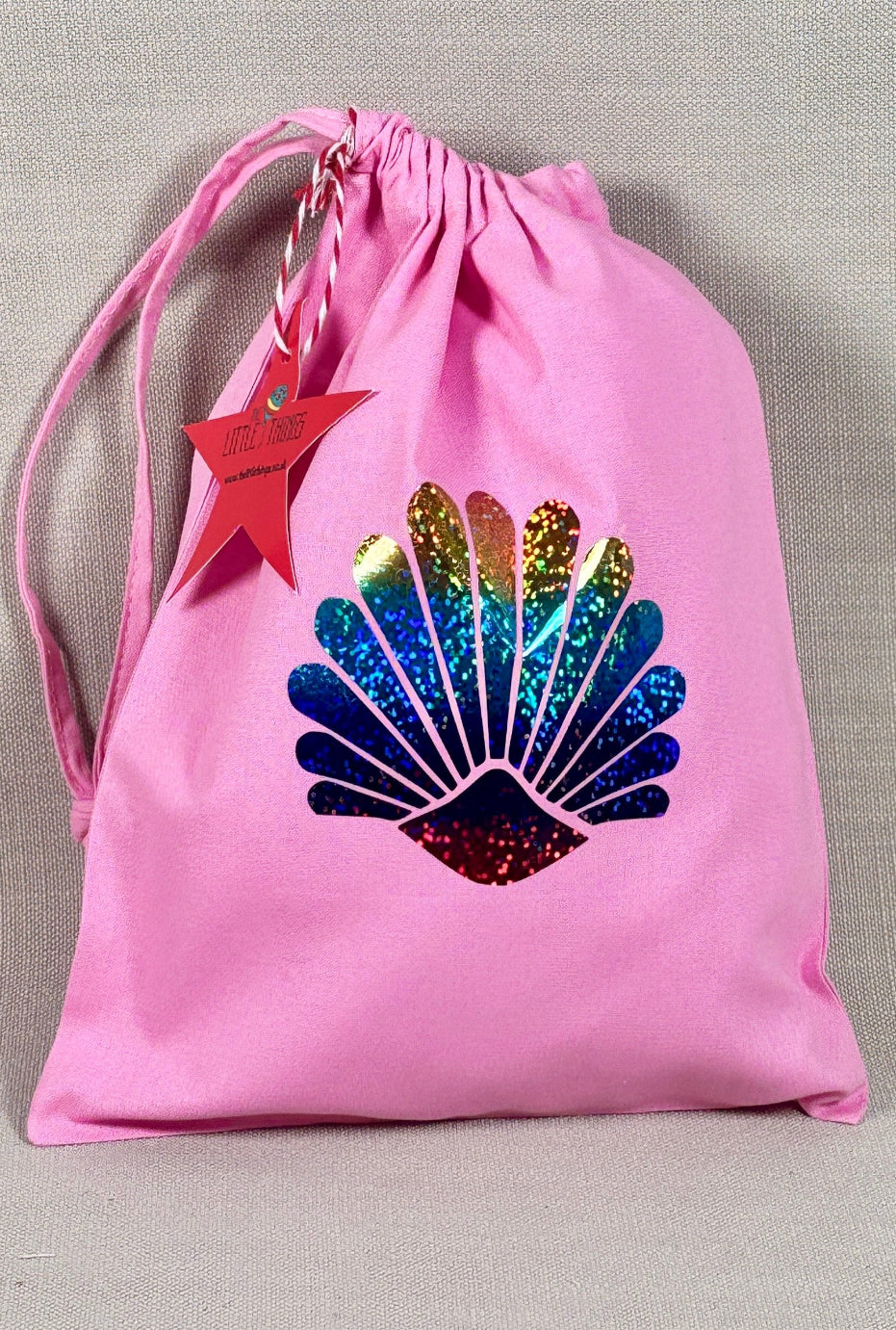 Pink drawstring bag with rainbow shell
