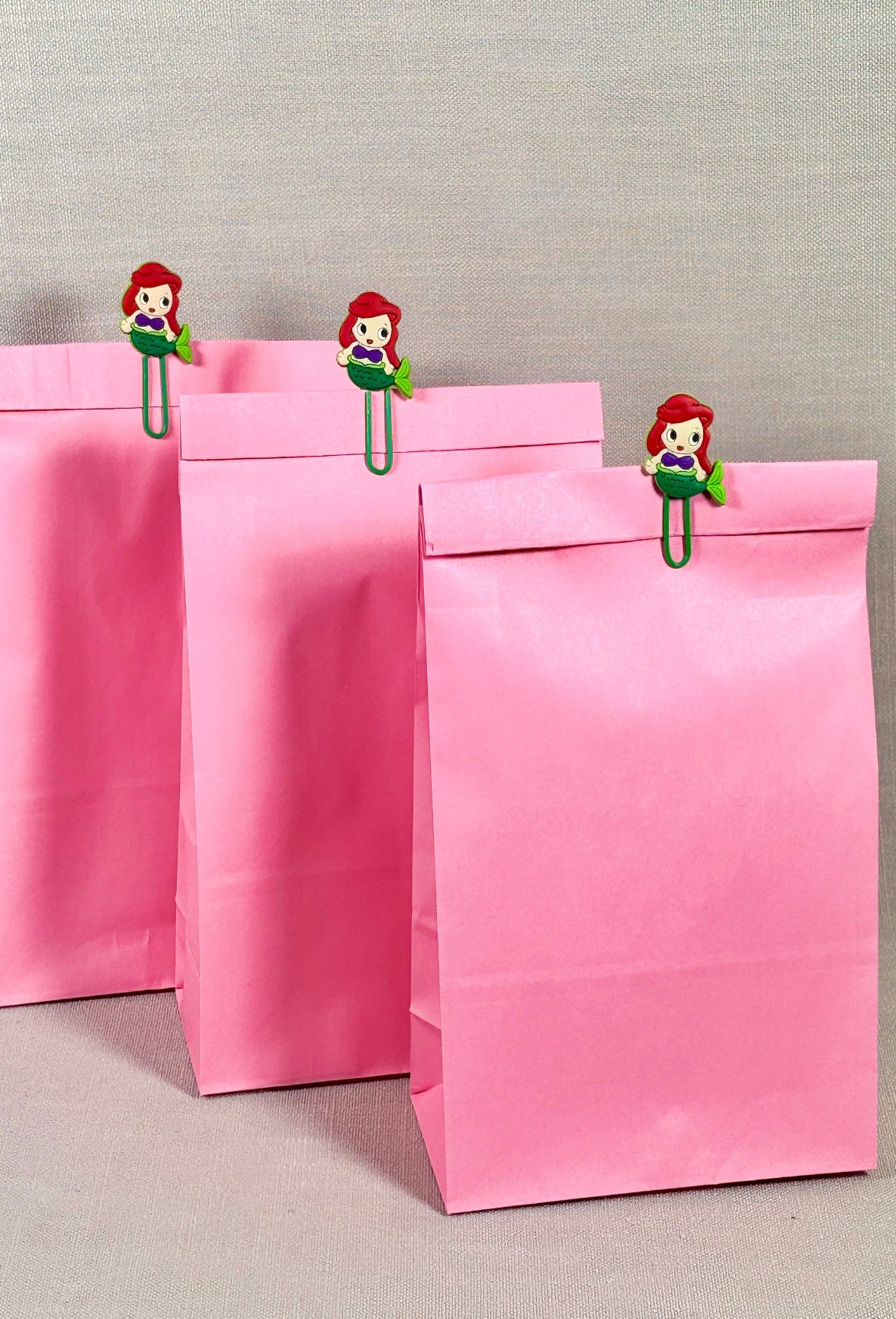 Pink paper bags with decorative mermaid clips