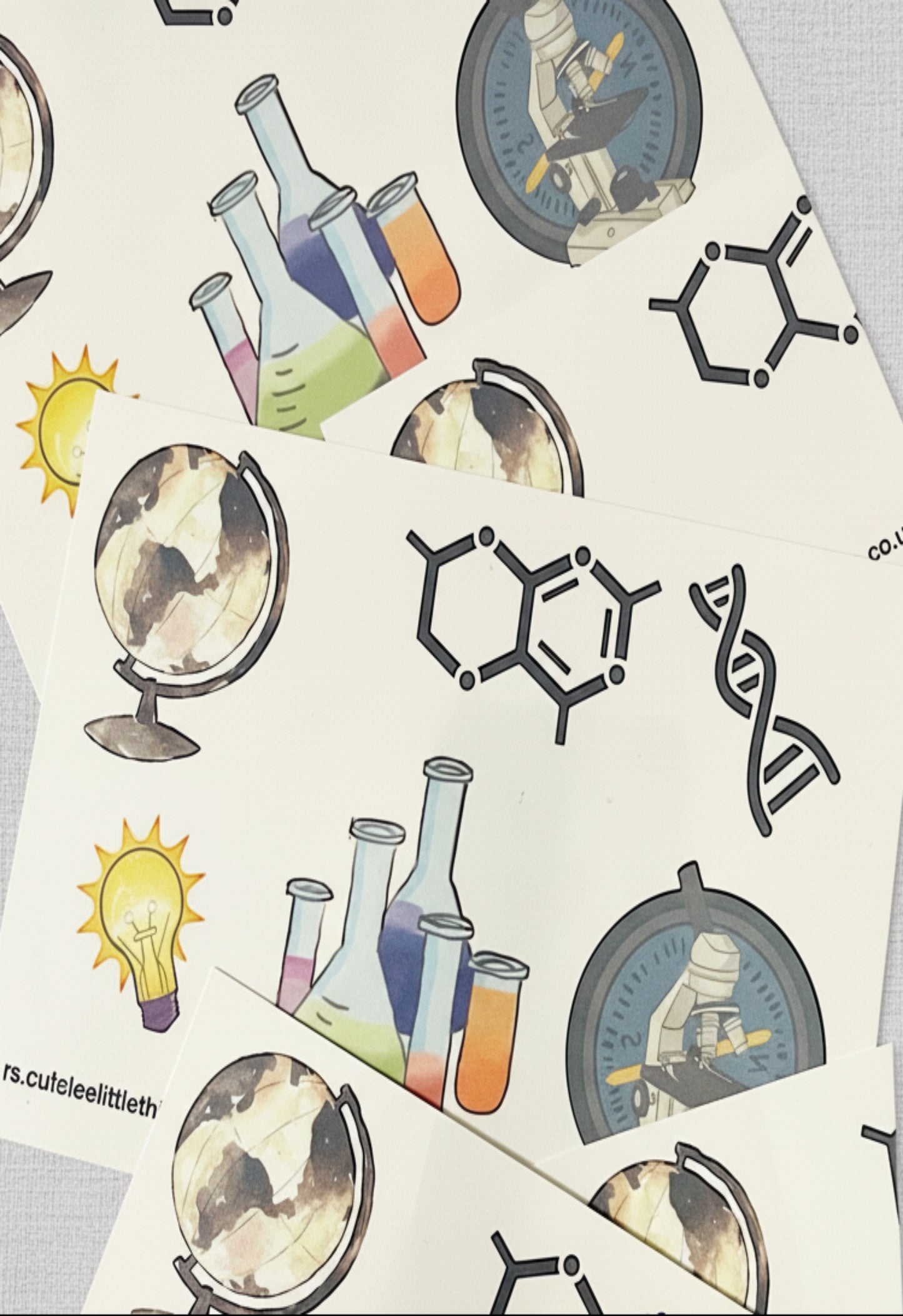 Sheets of science-themed tattoos featuring various scientific symbols and motifs.