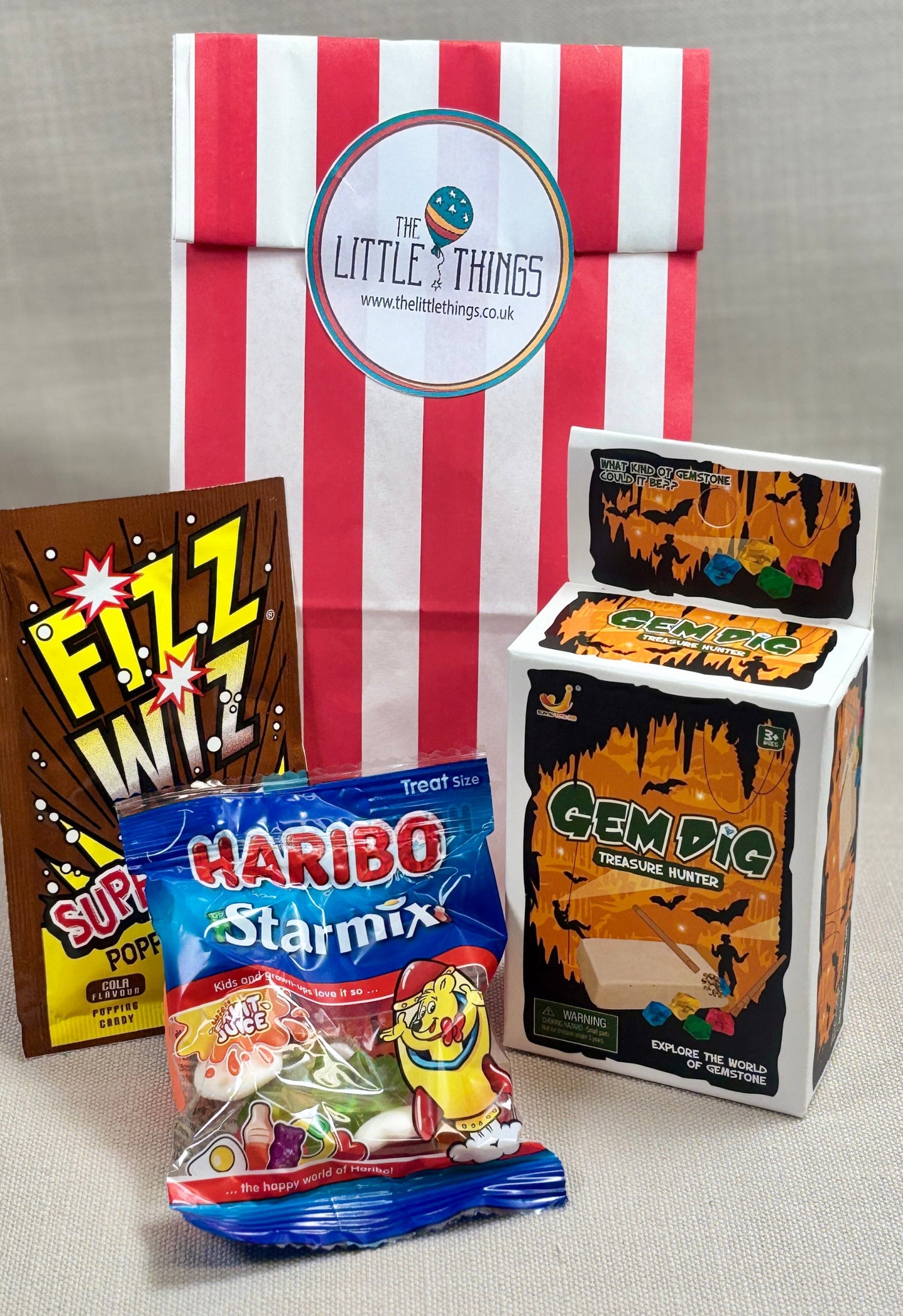Red stripped Paper party bag including Haribo Starmix and Gem dig  and fizz wiz