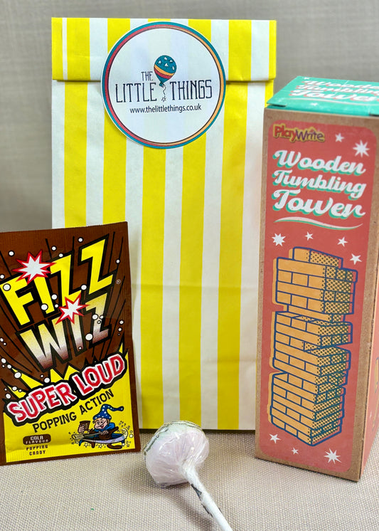 Three products includes a lollipop, 'Fizz Whizz', and a 'Wooden Tumbling Tower' with a Yellow striped paper party bag