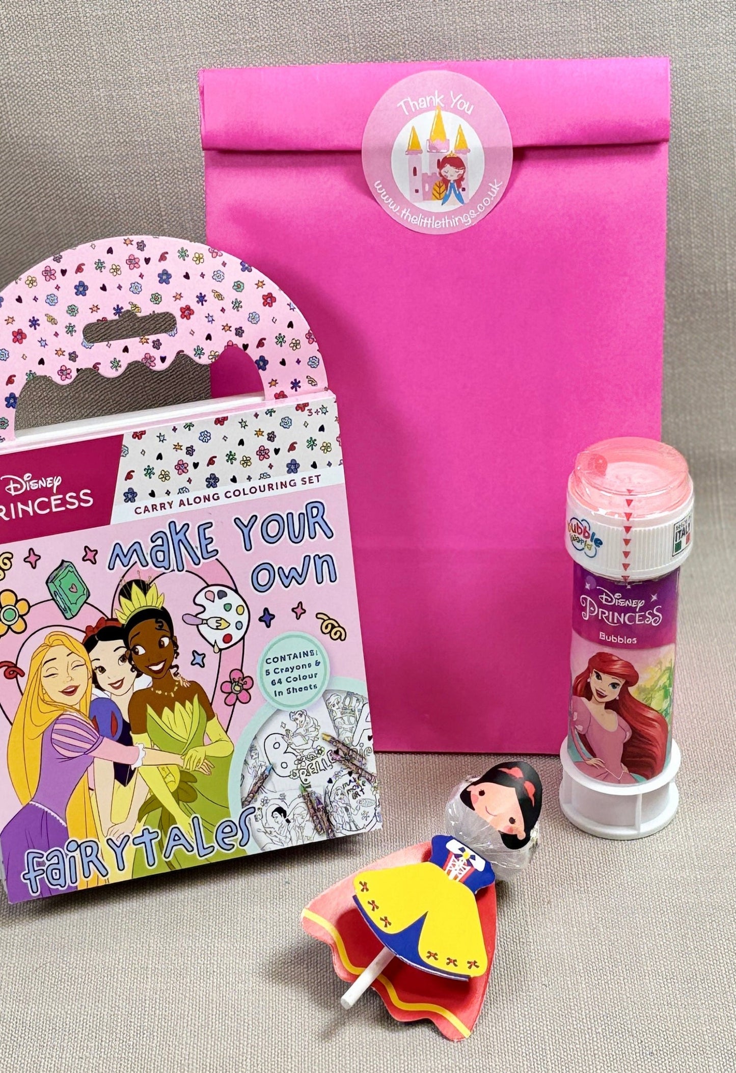 Pink paper overt bag with princess sticker. Party bag includes Disney Princess colouring book, princess bubbles and a princess lolly.