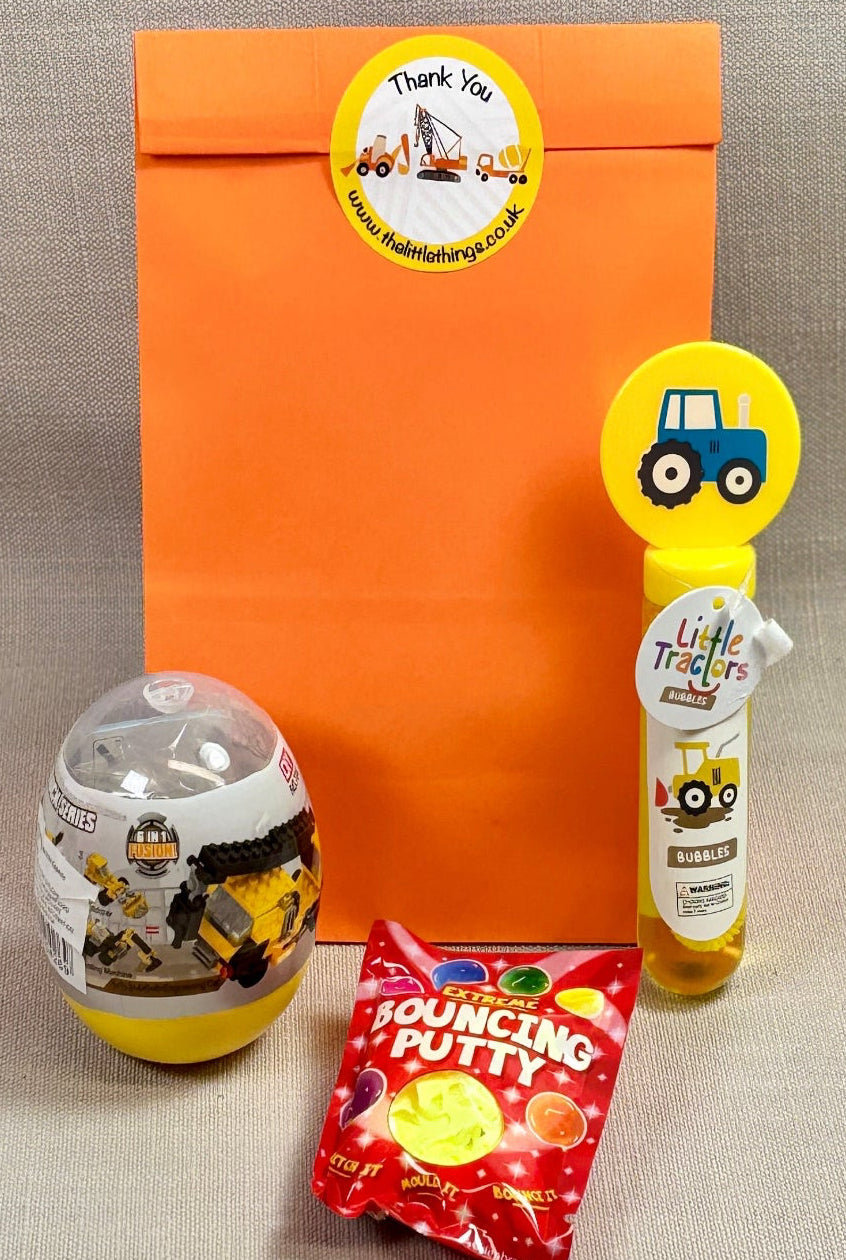 Orange paper party bag with Construction sticker. Bag included bubbles, Bouncy purrs and a construction brick set. 