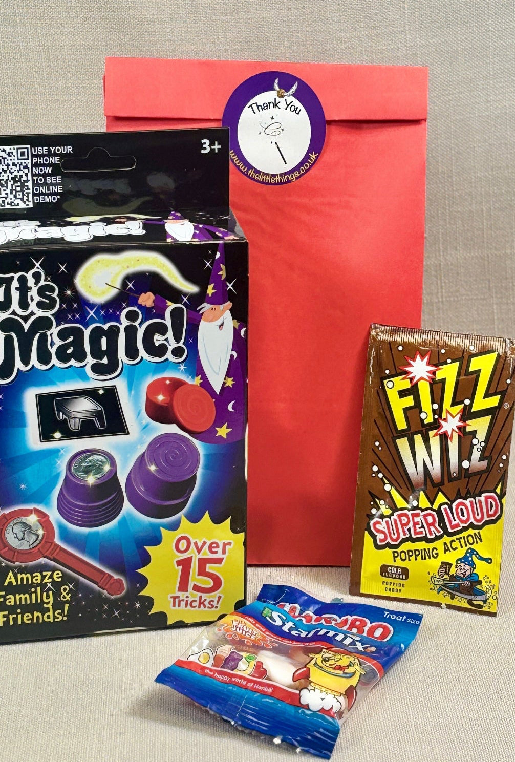 Red paper party bag, With Harry Poppy themed sticker. Included a magic trick set, fizz whizz and haribo sweets