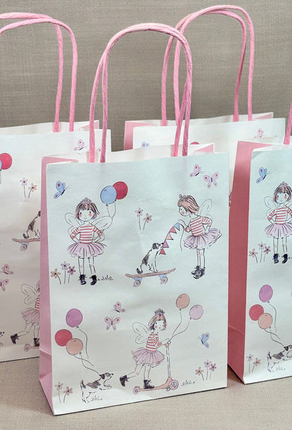 Set of three paper bags with pink handles and illustrations of a girl with balloons.