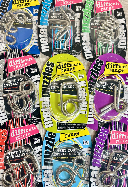 Collection of metal puzzles in colorful packaging with 'difficult range' text.