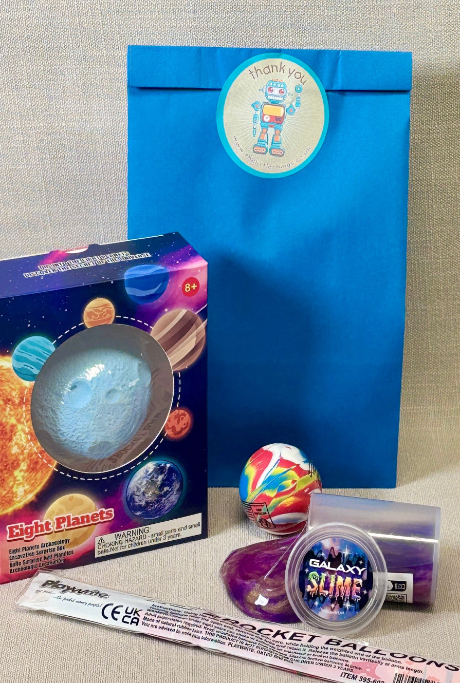 Collection of space-themed toys and packaging on a neutral background