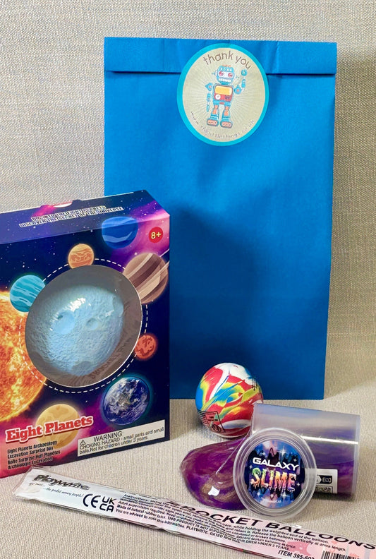 Collection of space-themed toys and packaging on a neutral background