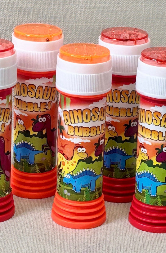 Set of small cylindrical containers with colorful labels on a gray background