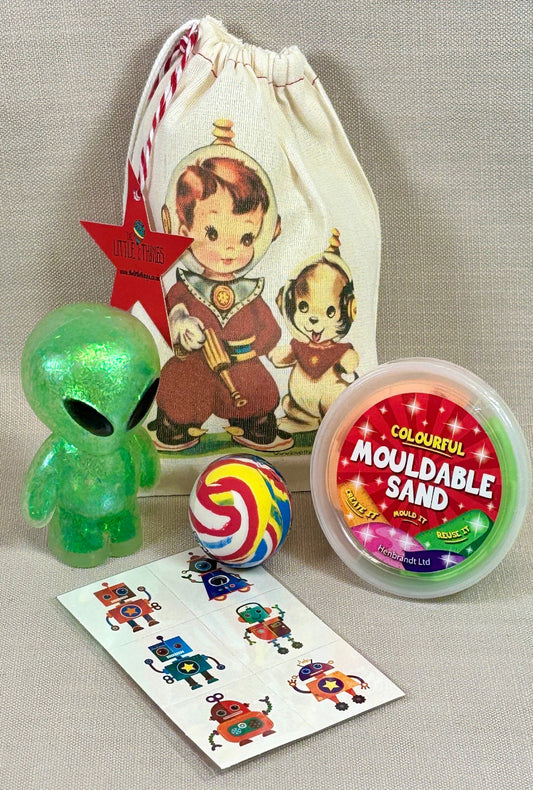 Vintage fabric party bag with space boy image on front. Included fillers, green slushy alien figure, a container of mouldable sand, robot temp arty tattoos, and a jet ball. .