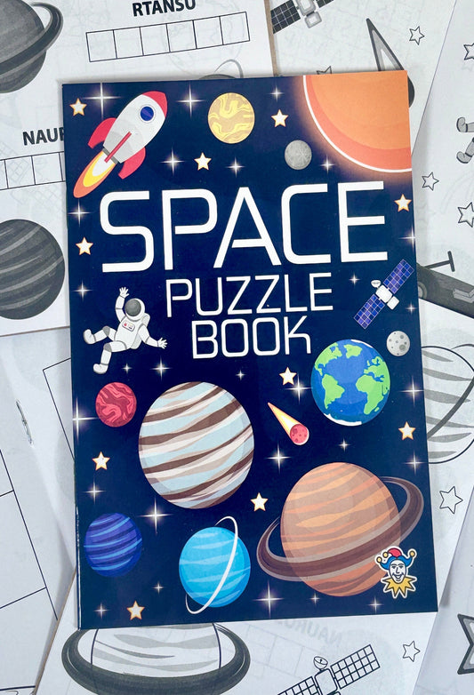 Space-themed puzzle book with space-themed coloring pages in the background