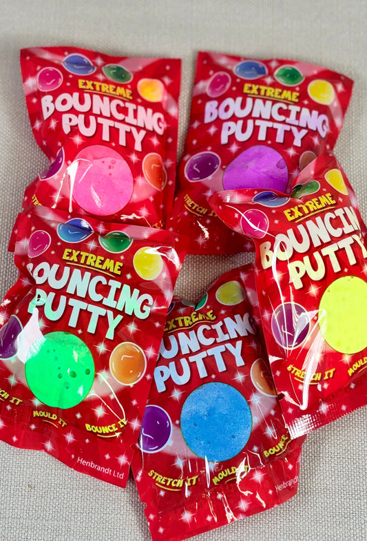 Multiple packages of Extreme Bouncing Putty on a gray background