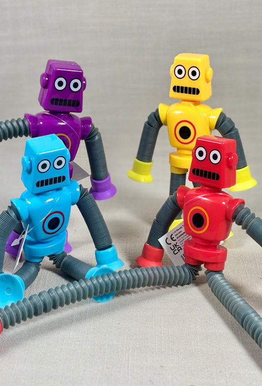 Four colorful robot toys with flexible arms and legs on a gray background