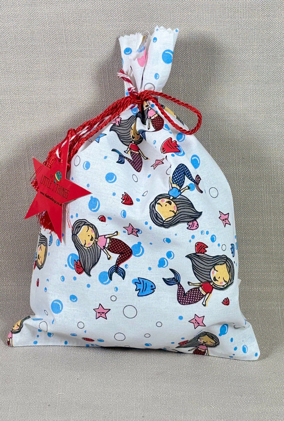Fabric drawstring bag with cartoon characters on a beige background