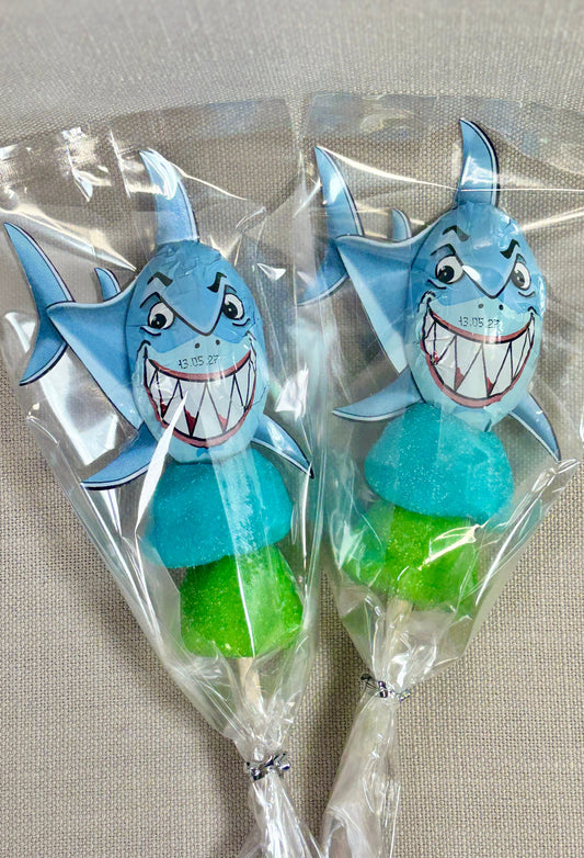 Two shark-shaped lollipops with marshmallow in clear plastic bags