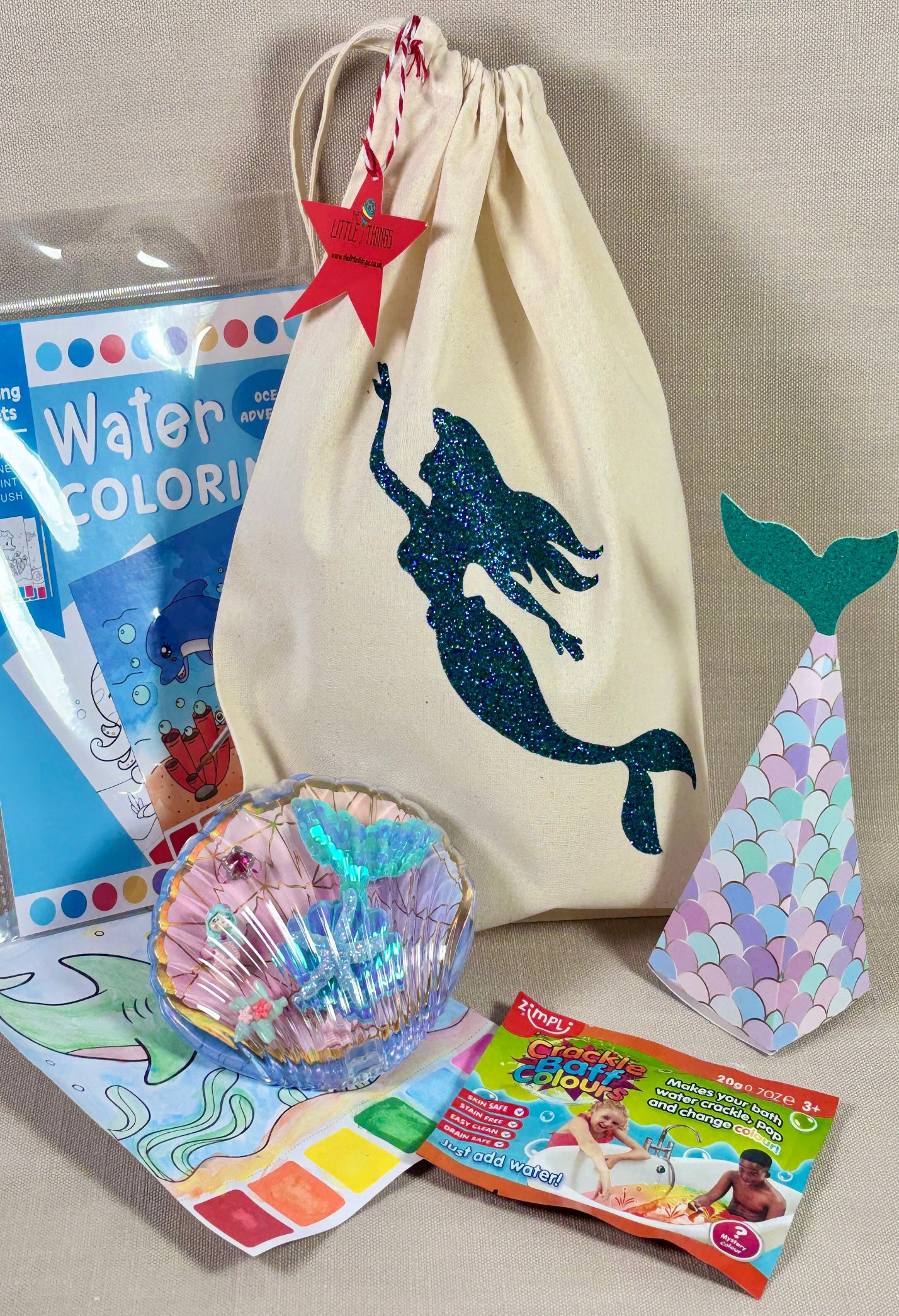 Mermaid-themed drawstring bag with coloring book, crayons, and other items