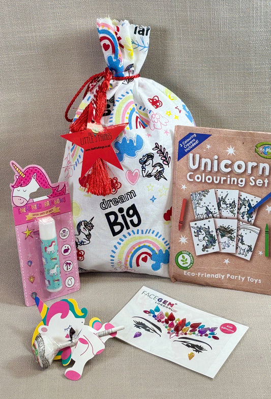 Unicorn fabric party bag with fillers. Including lip balm, face gems, Eco colouring kit and a lolly.