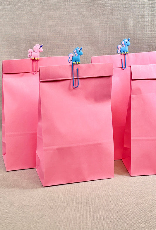 Paper Party bags with unicorn paper clip to seal the bag. 