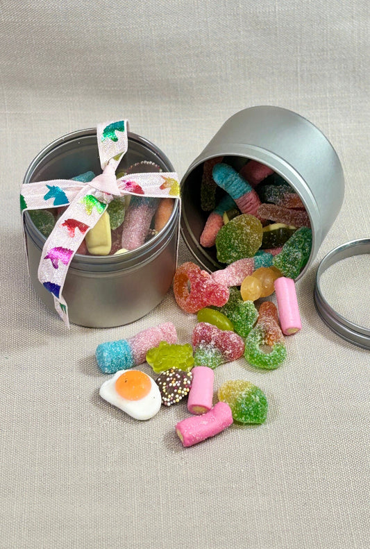 Tin full of pic n mix ties with a unicorn ribbon. 