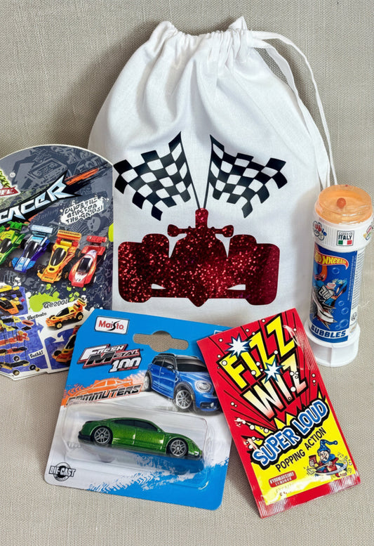 A collection of themed items featuring a white drawstring bag with a red glitter race car and checkered flags, alongside a car bubbles, fresh metal car, fix whzz sweet and a racing car building block set..